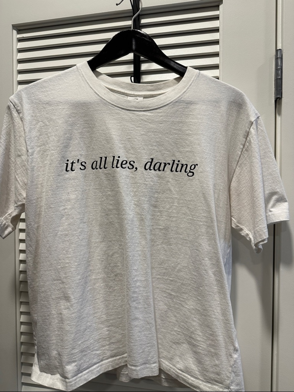 White Graphic Tee with "it's all lies, darling"